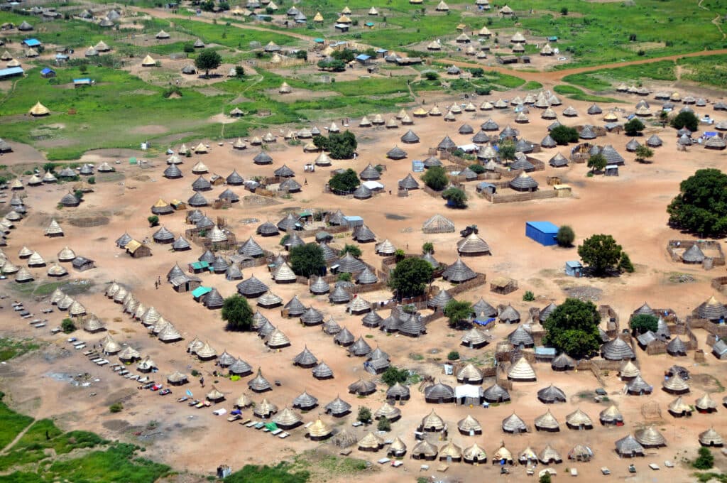 Traditional African housing, these thatched-roof huts are located on the outskirts of Juba, the capital of South Sudan. Aerial from a low altitude.