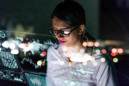 woman engineer looking at various information in screen of futuristic interface.