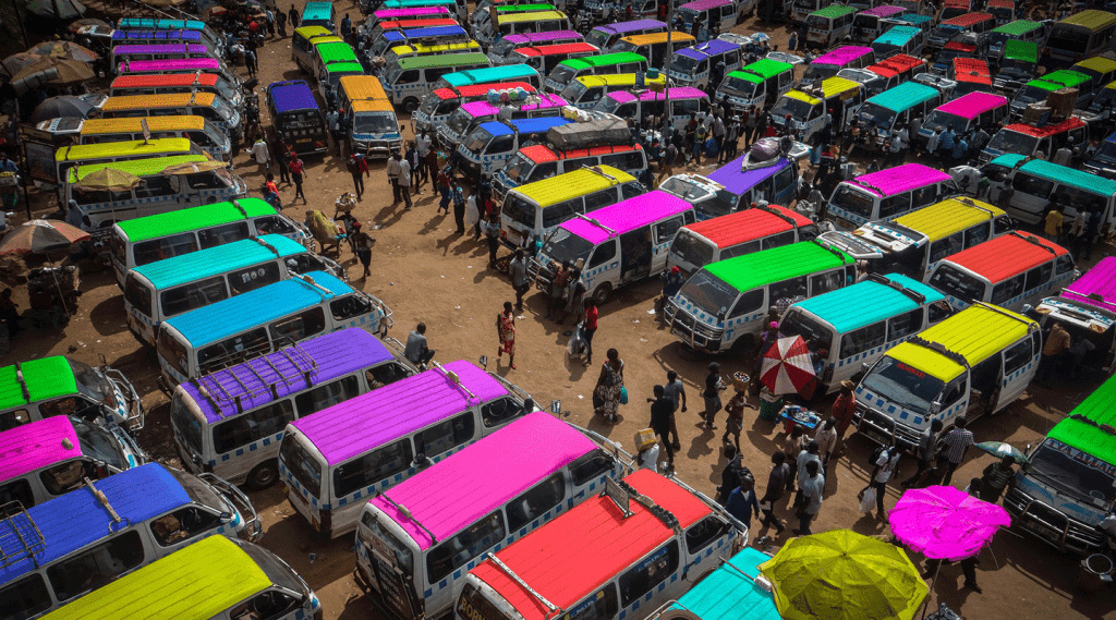 Public transport vehicles with colorful roofs in Kampala, Uganda