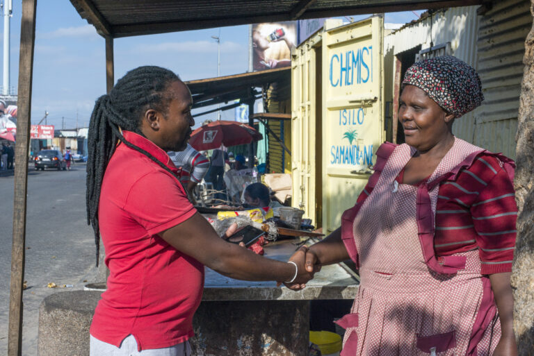 A man and woman shake hands in Cape Town, South Africa.